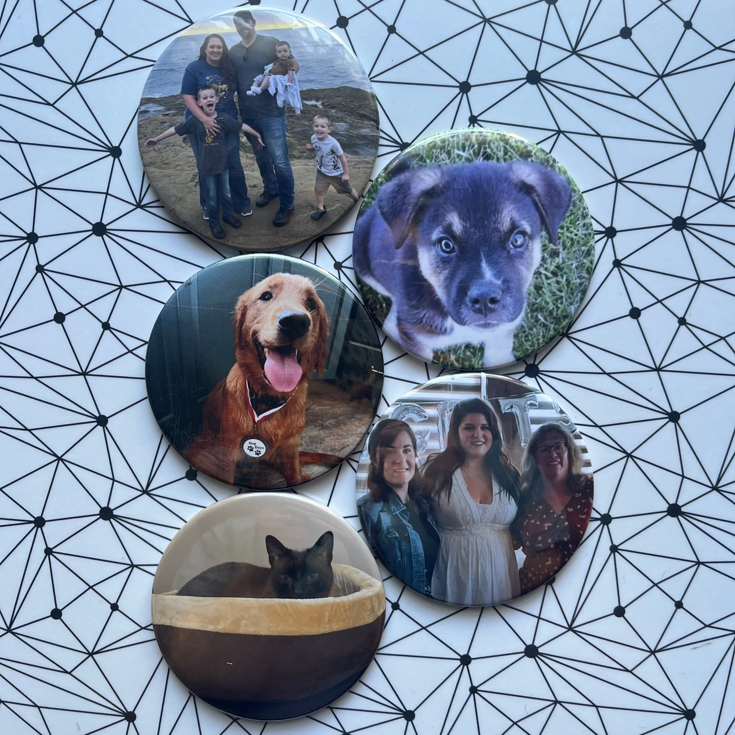 Set of five circular photo buttons with different images on a geometric patterned surface