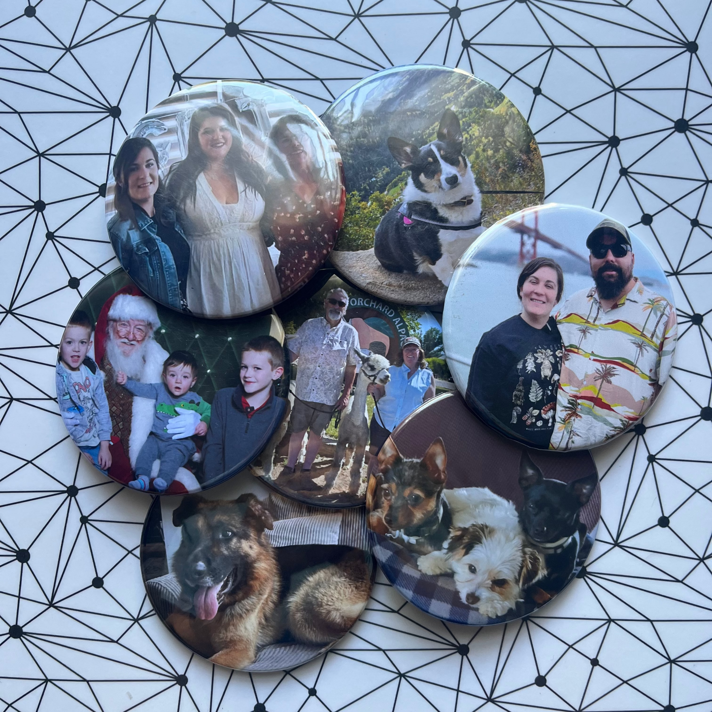 Collection of photo magnets with various images on a geometric patterned surface