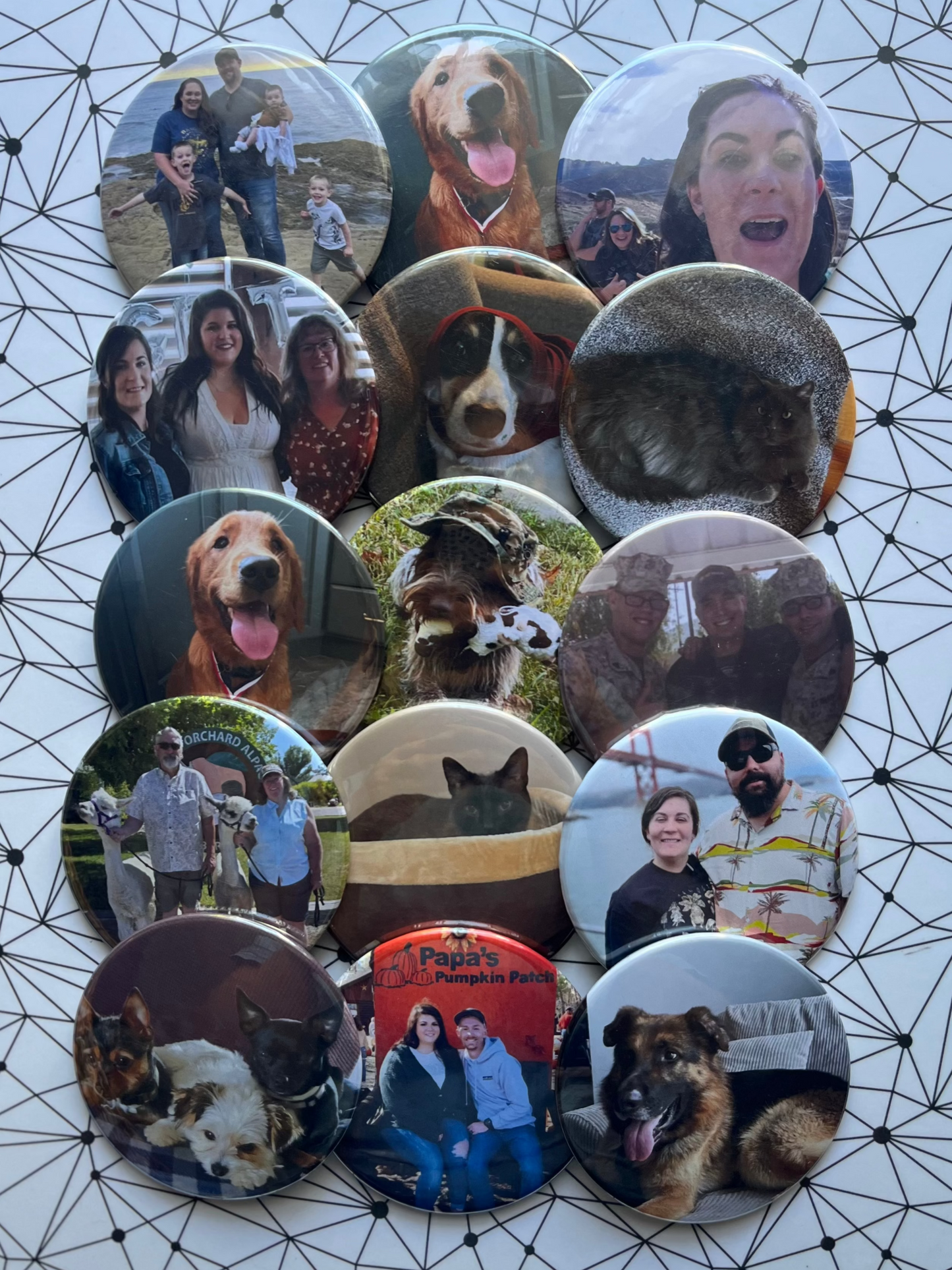 Collection of circular photo prints featuring people and dogs on a geometric patterned surface.