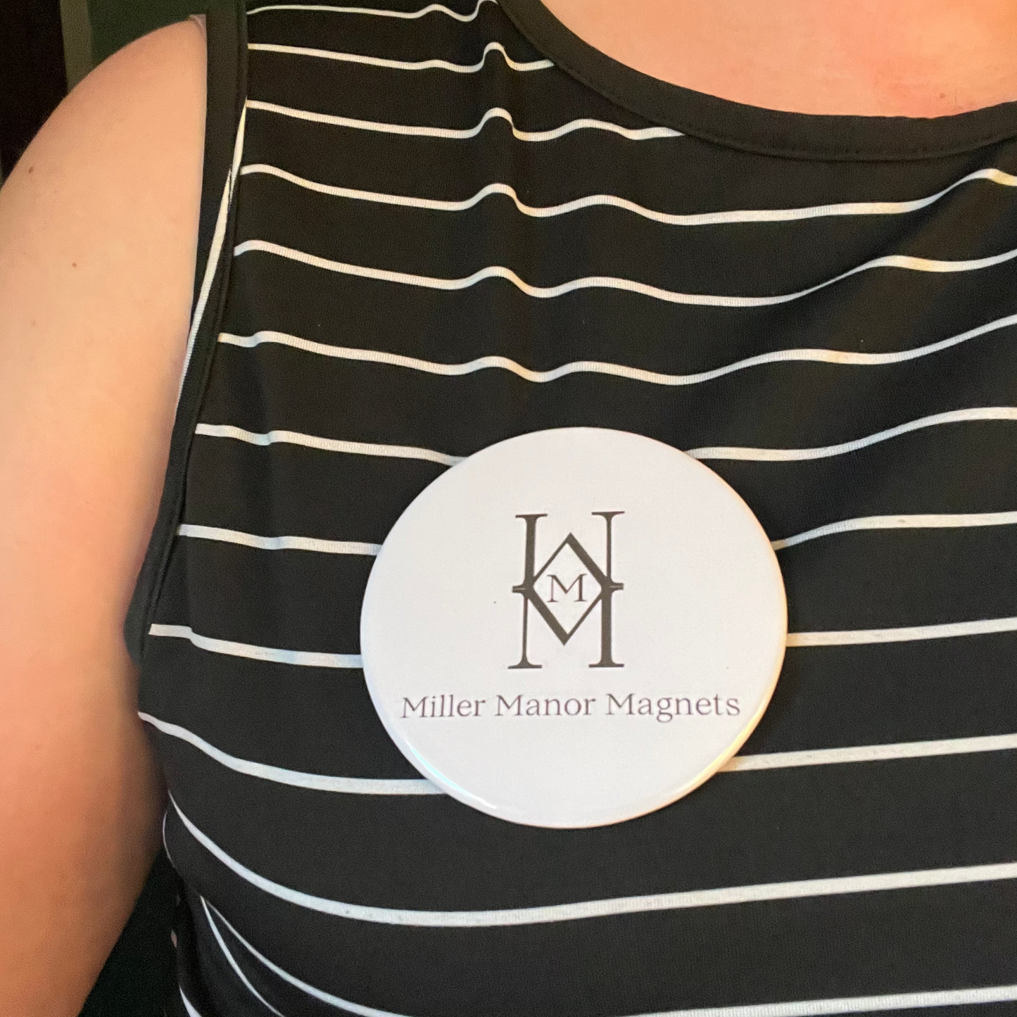 Black and white striped shirt with a visible brand logo on a person