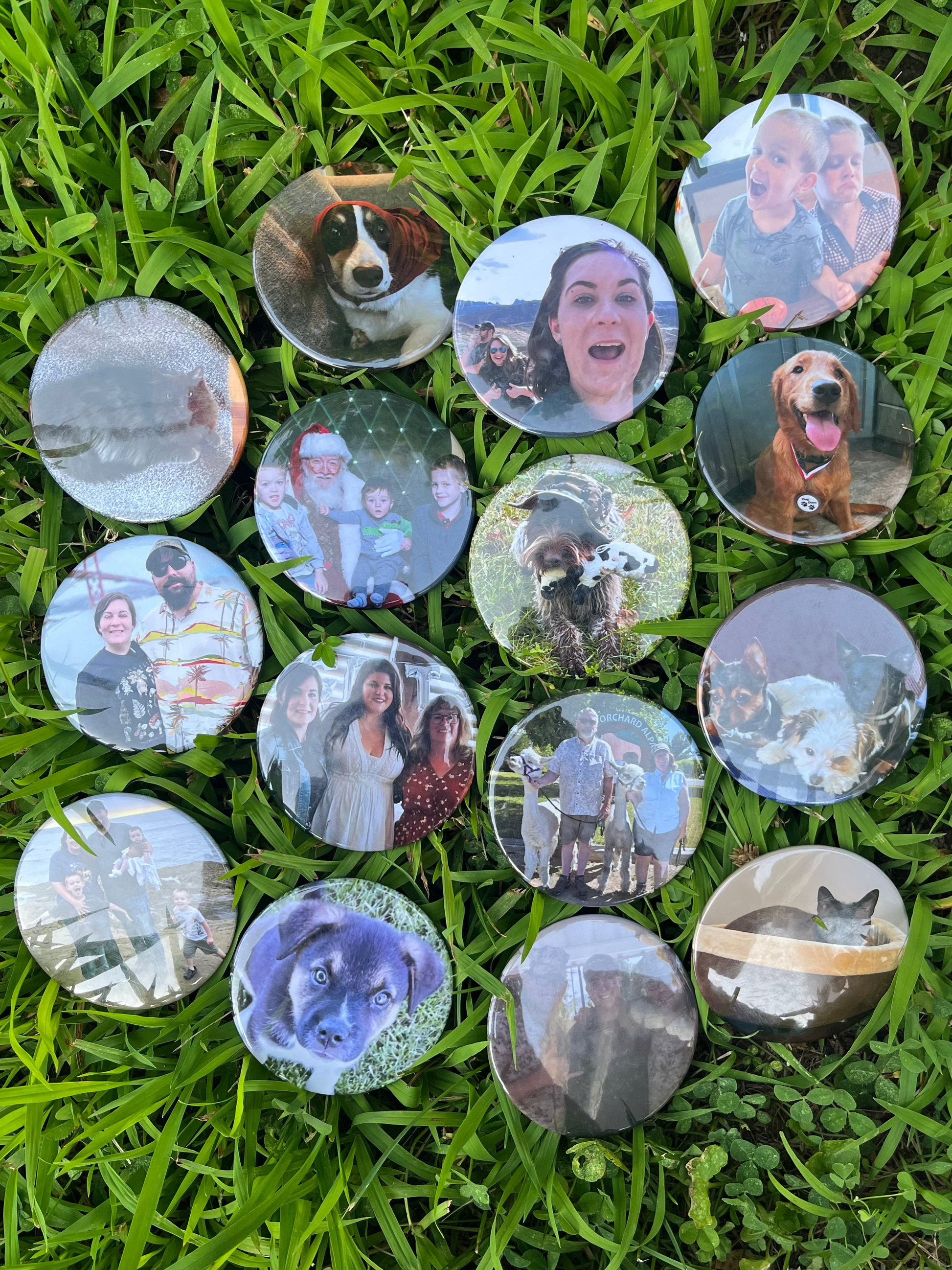 Circular photo prints of dogs and people arranged on grass